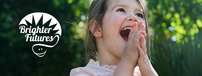 Girl laughing with Brighter Futures logo