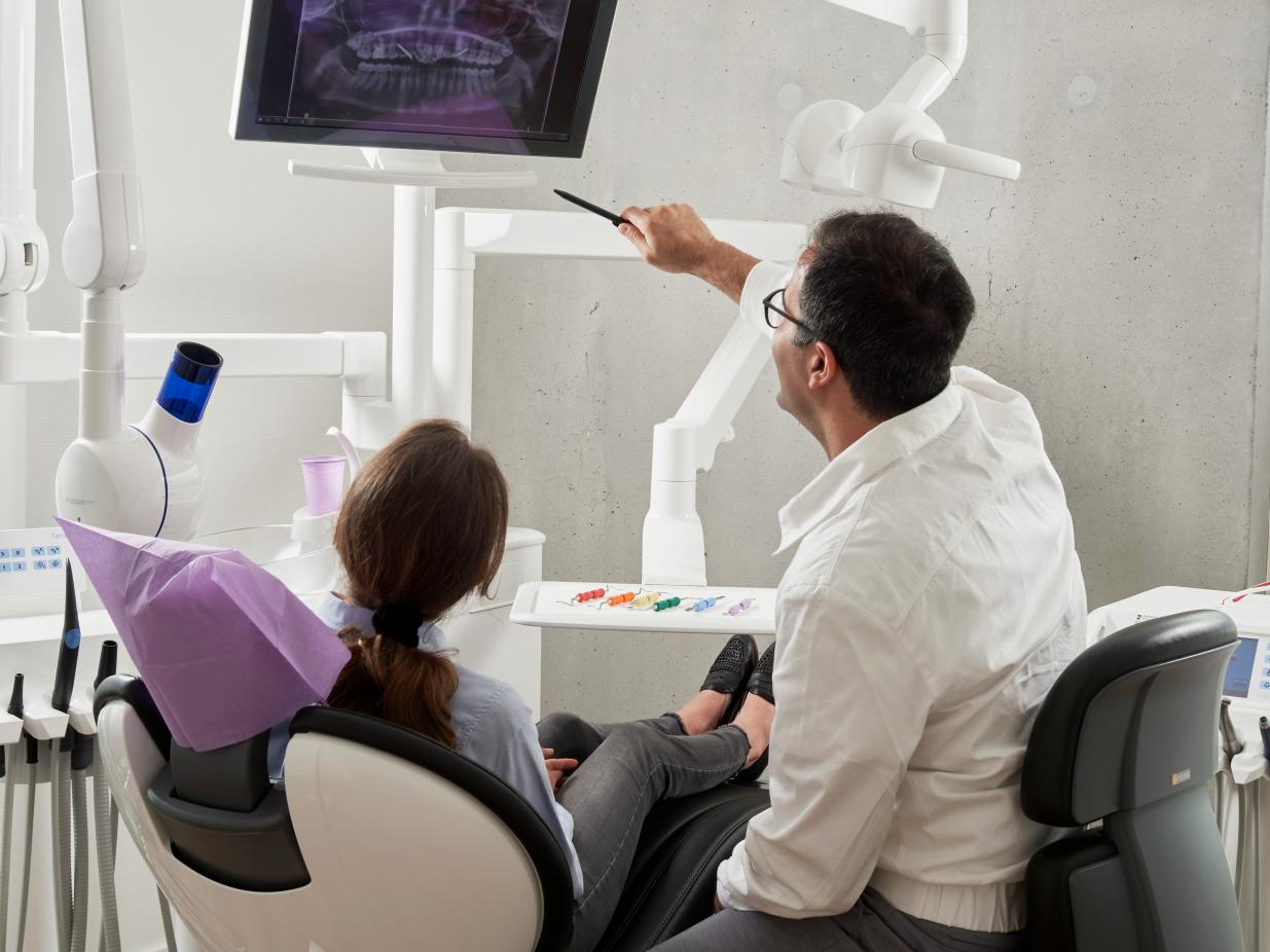 A dentist explains dental xrays to a patient