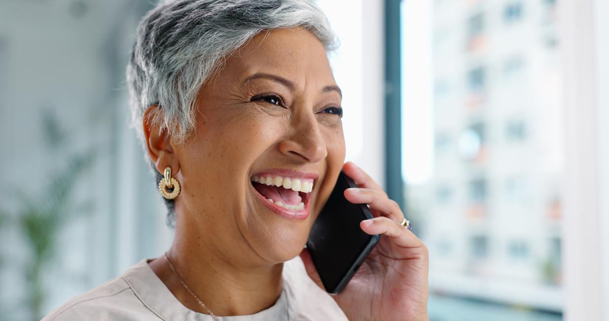 A woman talking on the phone and laughing