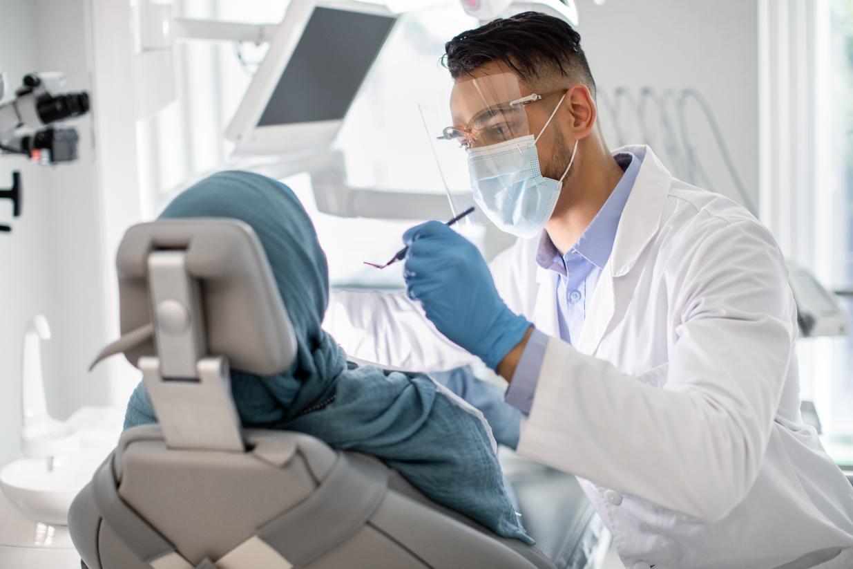 Dentist checking patient's teeth