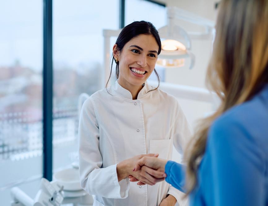 Dentist shaking hand of patient