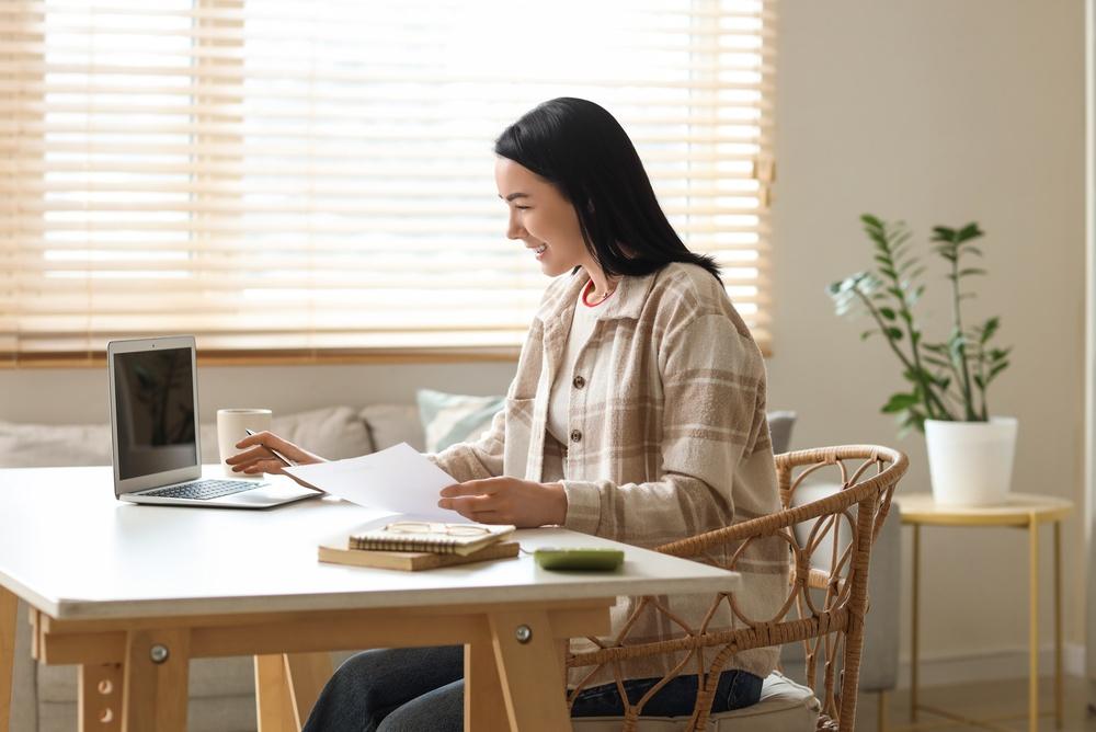 Woman on computer looking at bills