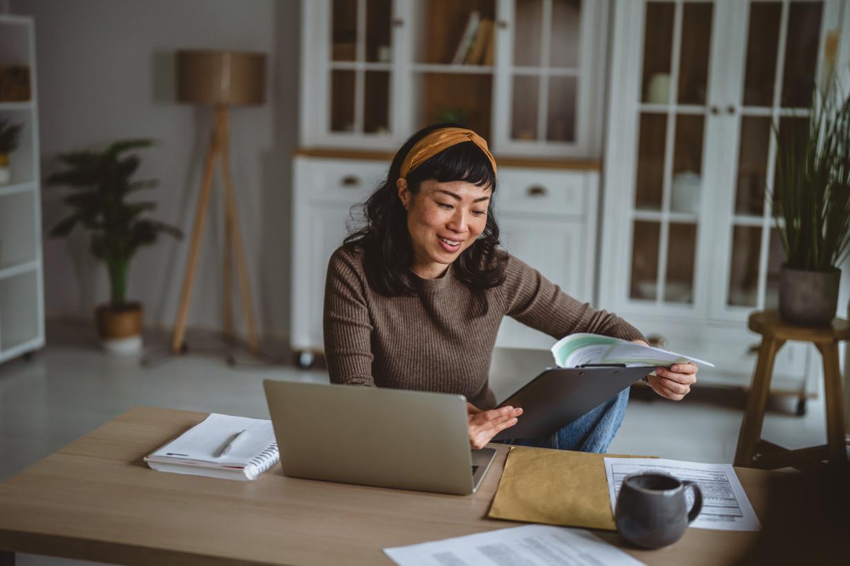 Woman sitting at desk looking at papers