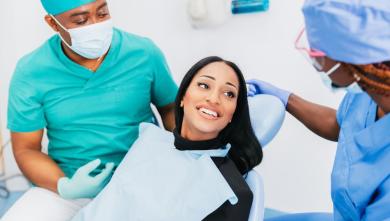 Person in dentist chair smiling at dentist