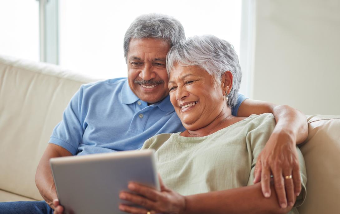 Happy senior couple viewing tablet together.